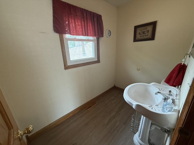 619 25th Ave, Minot, ND 58703 - bathroom featuring wood finished floors and baseboards