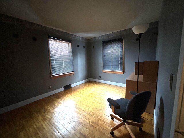 1107 SE 2nd St, Minot, ND 58701 - sitting room featuring wood finished floors and baseboards
