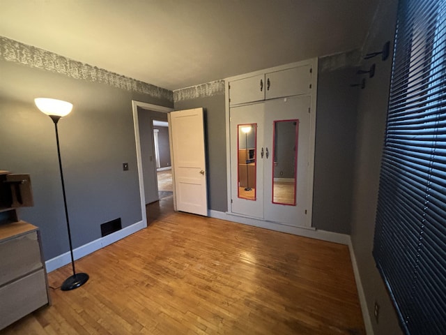 1107 SE 2nd St, Minot, ND 58701 - unfurnished bedroom with light wood-type flooring and baseboards