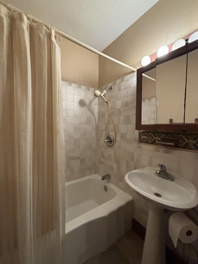 1107 SE 2nd St, Minot, ND 58701 - bathroom with shower / tub combo, tile walls, and tasteful backsplash