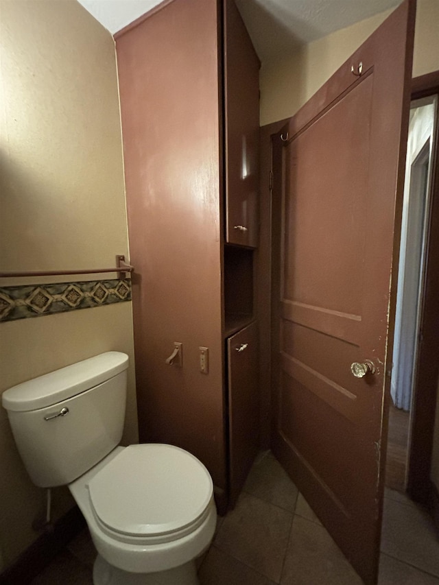 1107 SE 2nd St, Minot, ND 58701 - bathroom with toilet and tile patterned flooring