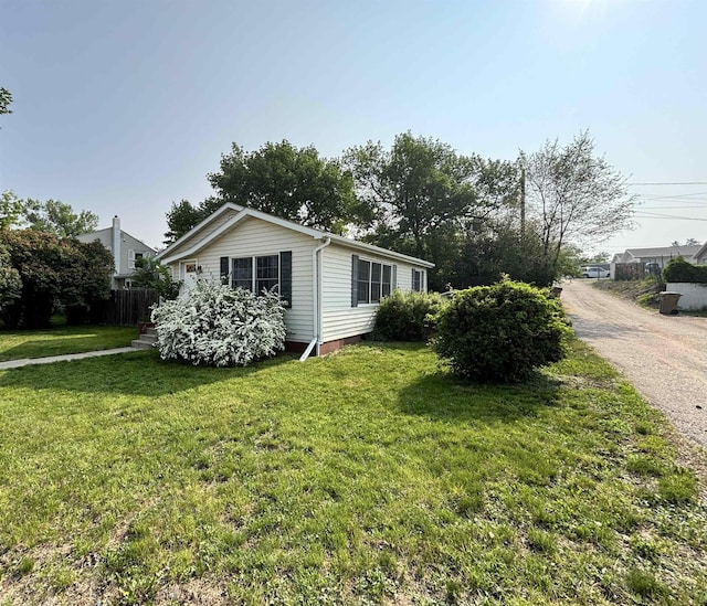 1107 SE 2nd St, Minot, ND 58701 - view of side of home featuring a lawn