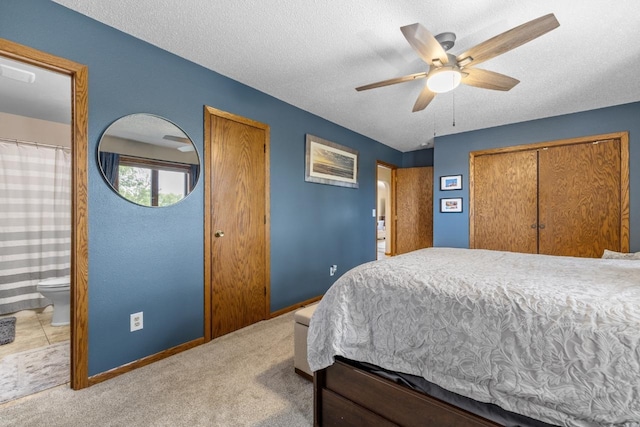 2509 11th Ave, Minot, ND 58703 - bedroom featuring a textured ceiling, baseboards, carpet floors, a ceiling fan, and ensuite bath