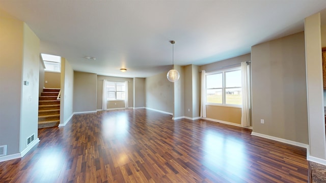 2947 8th St, Minot, ND 58703 - spare room with dark wood-type flooring, stairway, and baseboards