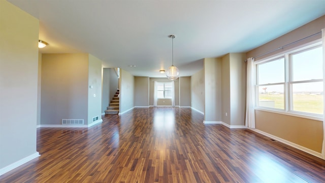 2947 8th St, Minot, ND 58703 - empty room with dark wood-style floors, stairs, and baseboards