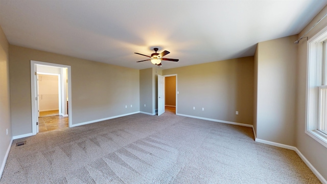 2947 8th St, Minot, ND 58703 - spare room featuring carpet, a ceiling fan, and baseboards
