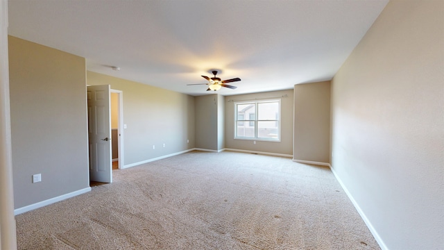 2947 8th St, Minot, ND 58703 - carpeted spare room with a ceiling fan and baseboards