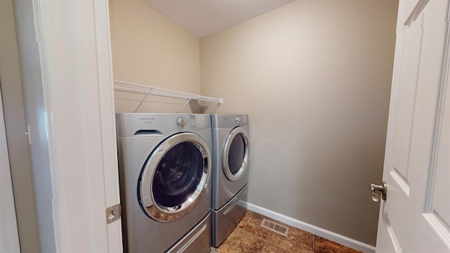 2947 8th St, Minot, ND 58703 - laundry area with washing machine and clothes dryer and baseboards