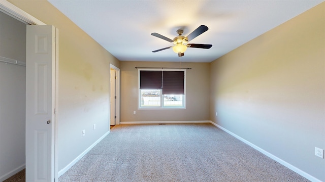 2947 8th St, Minot, ND 58703 - empty room featuring carpet floors, a ceiling fan, and baseboards
