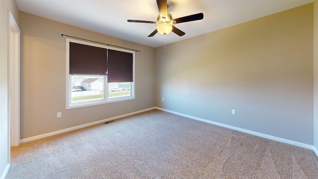 2947 8th St, Minot, ND 58703 - carpeted empty room with a ceiling fan and baseboards