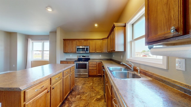 2947 8th St, Minot, ND 58703 - kitchen with appliances with stainless steel finishes, a sink, healthy amount of natural light, a center island, and recessed lighting