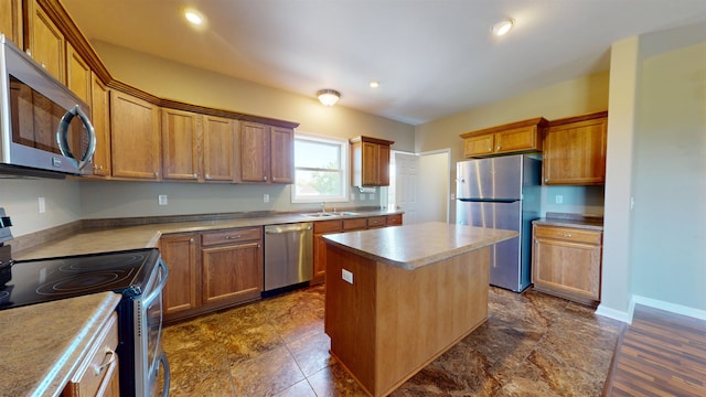 2947 8th St, Minot, ND 58703 - kitchen with appliances with stainless steel finishes, a kitchen island, a sink, brown cabinetry, and recessed lighting