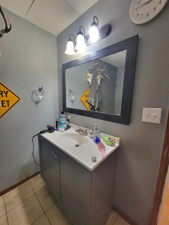 4920 10th Ave NW, Minot, ND 58703 - bathroom with vanity, tile patterned flooring, and baseboards