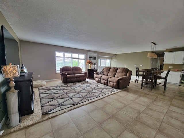 4920 10th Ave NW, Minot, ND 58703 - living area with a textured ceiling, baseboards, and light tile patterned floors