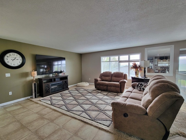 4920 10th Ave NW, Minot, ND 58703 - living room featuring baseboards, a textured ceiling, and a fireplace