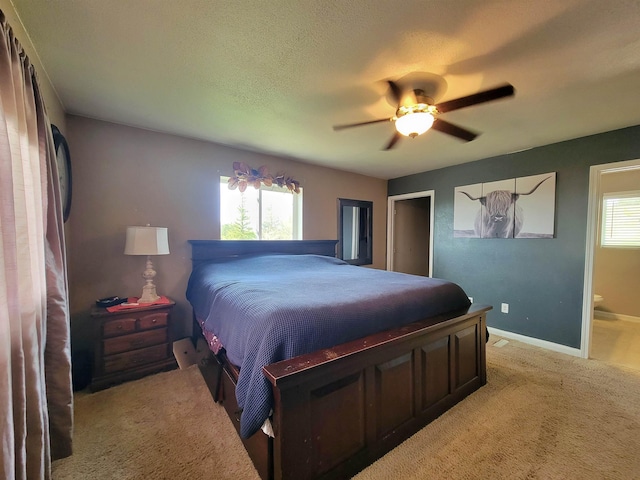4920 10th Ave NW, Minot, ND 58703 - bedroom featuring carpet floors, baseboards, a ceiling fan, and connected bathroom