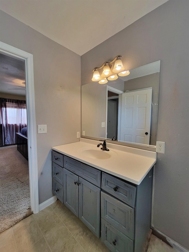 4920 10th Ave NW, Minot, ND 58703 - bathroom featuring vanity, baseboards, and tile patterned floors