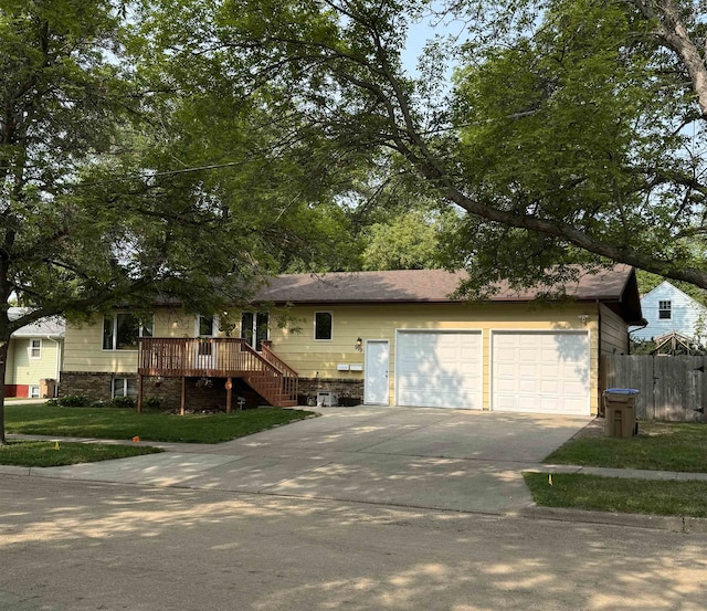 919 9th St, Minot, ND 58703 - view of front of house with driveway, stairway, a wooden deck, and an attached garage