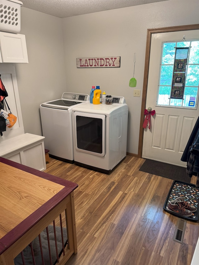 919 9th St, Minot, ND 58703 - washroom with washer and dryer and wood finished floors