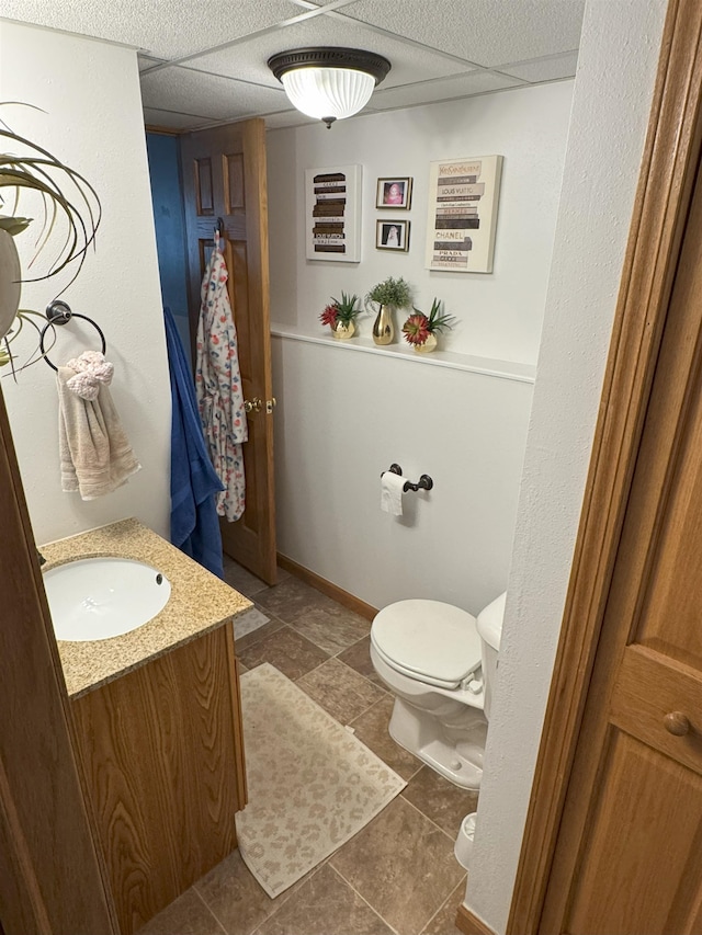 919 9th St, Minot, ND 58703 - bathroom featuring toilet, vanity, and baseboards