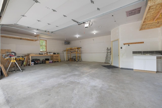 901 3rd St, Minot, ND 58701 - garage featuring a garage door opener and a workshop area