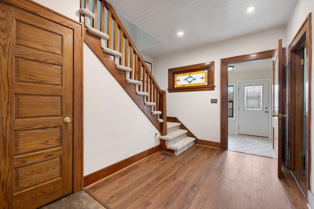 901 3rd St, Minot, ND 58701 - entryway with baseboards, stairway, wood finished floors, and recessed lighting