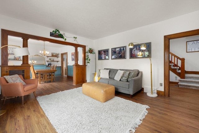 901 3rd St, Minot, ND 58701 - living room featuring a chandelier, wood finished floors, stairway, and baseboards