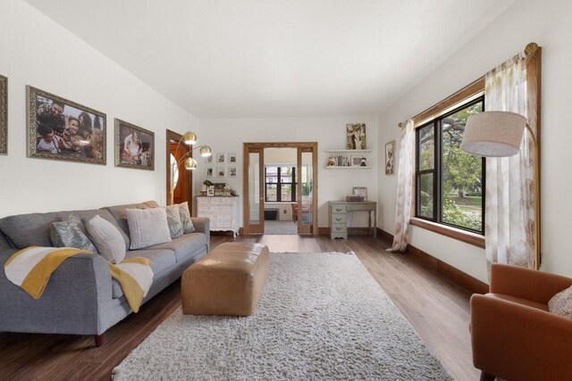 901 3rd St, Minot, ND 58701 - living room featuring plenty of natural light, wood finished floors, and baseboards