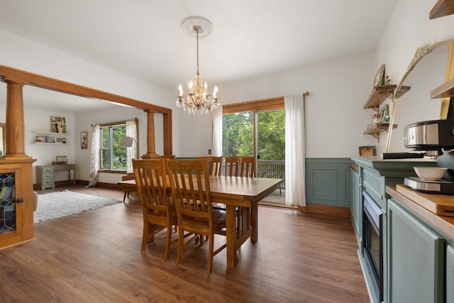 901 3rd St, Minot, ND 58701 - dining space featuring a chandelier, dark wood finished floors, decorative columns, and wainscoting