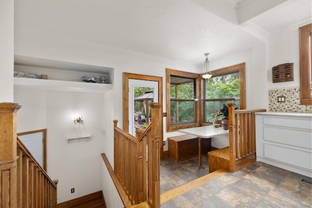 901 3rd St, Minot, ND 58701 - bathroom with plenty of natural light, stone finish floors, decorative backsplash, and vanity
