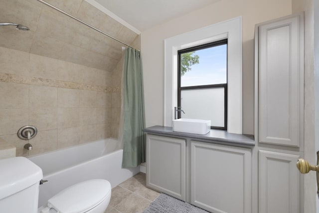 901 3rd St, Minot, ND 58701 - full bathroom with toilet, a sink, shower / bath combo with shower curtain, and tile patterned floors