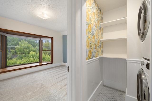 901 3rd St, Minot, ND 58701 - laundry room with stacked washer / drying machine, wainscoting, a textured ceiling, and light colored carpet