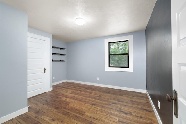 901 3rd St, Minot, ND 58701 - empty room featuring wood finished floors and baseboards