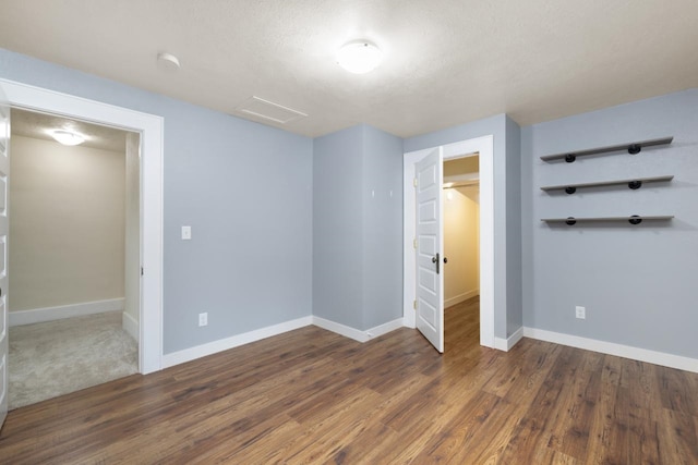 901 3rd St, Minot, ND 58701 - unfurnished bedroom featuring attic access, baseboards, and wood finished floors