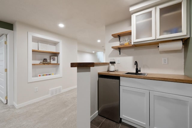 901 3rd St, Minot, ND 58701 - indoor wet bar featuring stainless steel fridge, baseboards, built in shelves, recessed lighting, and dark colored carpet