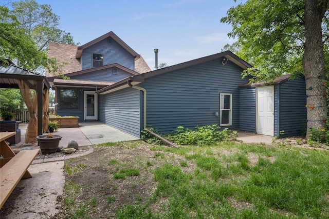 901 3rd St, Minot, ND 58701 - back of house with a patio and a gazebo