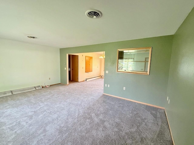 30 1st St, Sawyer, ND 58781 - unfurnished room featuring a baseboard radiator, carpet floors, baseboards, and baseboard heating