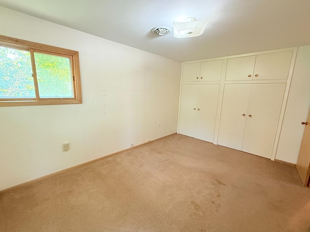 30 1st St, Sawyer, ND 58781 - unfurnished bedroom with light carpet, baseboards, and a closet