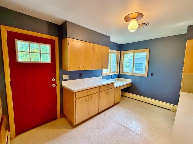 30 1st St, Sawyer, ND 58781 - kitchen featuring baseboard heating, light countertops, and baseboards
