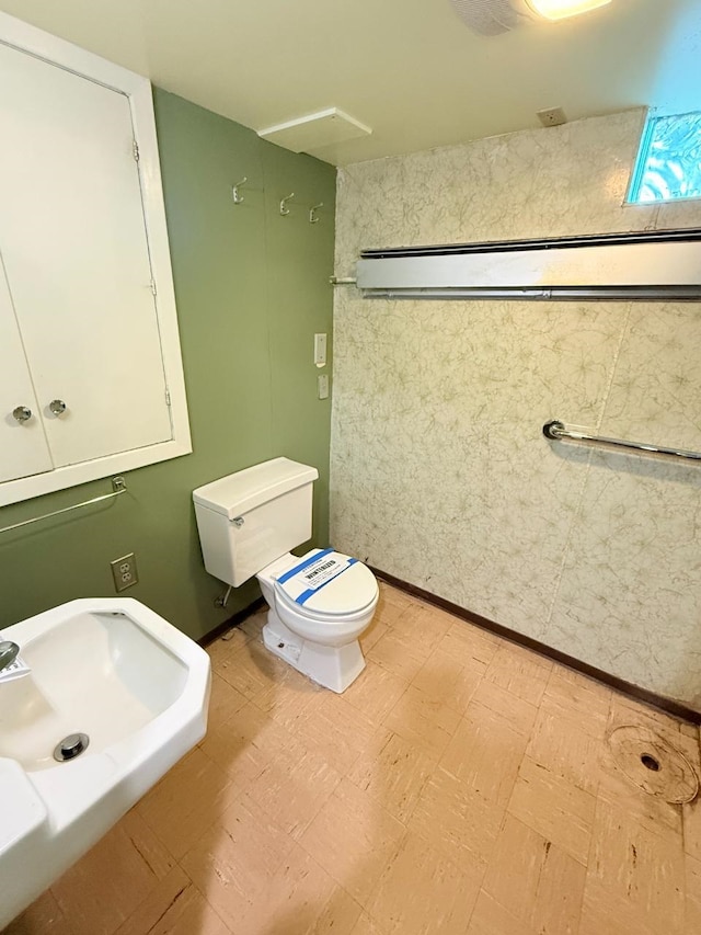 30 1st St, Sawyer, ND 58781 - bathroom featuring toilet, tile patterned floors, and a sink
