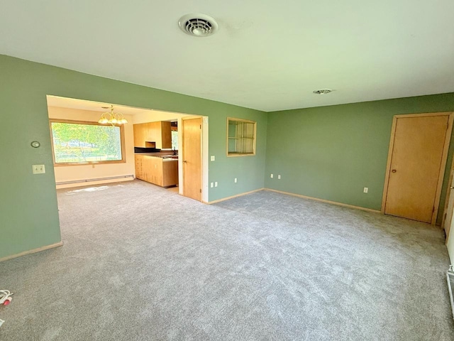 30 1st St, Sawyer, ND 58781 - unfurnished living room with a chandelier, baseboards, and light colored carpet