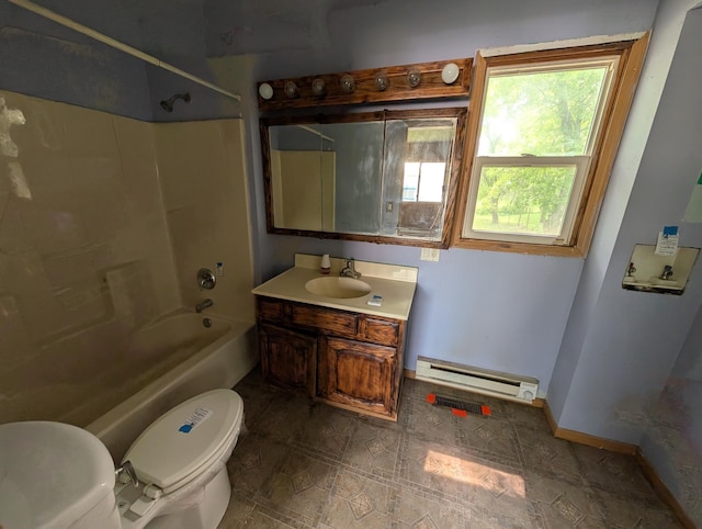 2704 SE 9th Ave, Minot, ND 58701 - full bathroom featuring a baseboard heating unit, toilet,  shower combination, vanity, and baseboards
