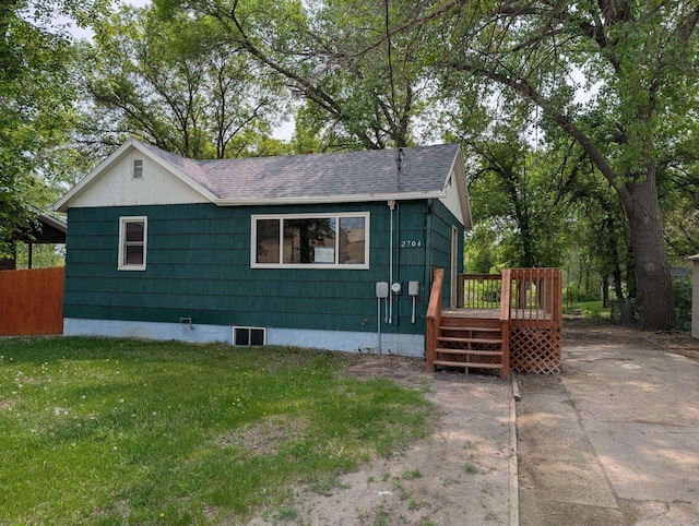 2704 SE 9th Ave, Minot, ND 58701 - view of front facade with a wooden deck and a shingled roof