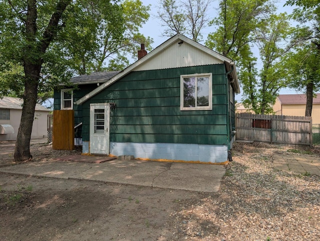 2704 SE 9th Ave, Minot, ND 58701 - view of property exterior with a chimney