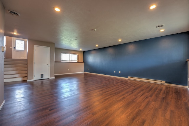 3421 8th St, Minot, ND 58703 - empty room with a baseboard radiator, baseboards, dark wood-style flooring, and recessed lighting