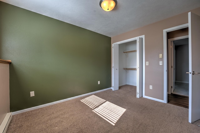 3421 8th St, Minot, ND 58703 - unfurnished bedroom with a baseboard heating unit, carpet floors, baseboards, and a closet