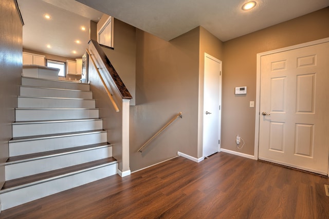 3421 8th St, Minot, ND 58703 - stairway with wood finished floors, baseboards, and recessed lighting