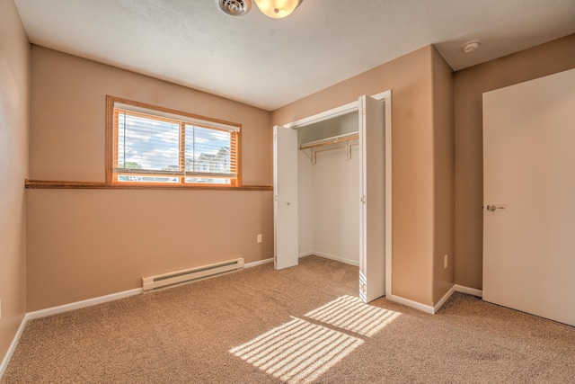 3421 8th St, Minot, ND 58703 - unfurnished bedroom with baseboard heating, carpet flooring, a closet, and baseboards