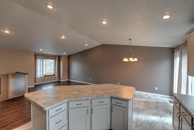 3421 8th St, Minot, ND 58703 - kitchen with recessed lighting, a chandelier, lofted ceiling, baseboards, and light countertops