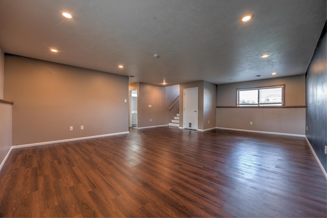 3421 8th St, Minot, ND 58703 - unfurnished room with stairway, baseboards, recessed lighting, and dark wood-style flooring